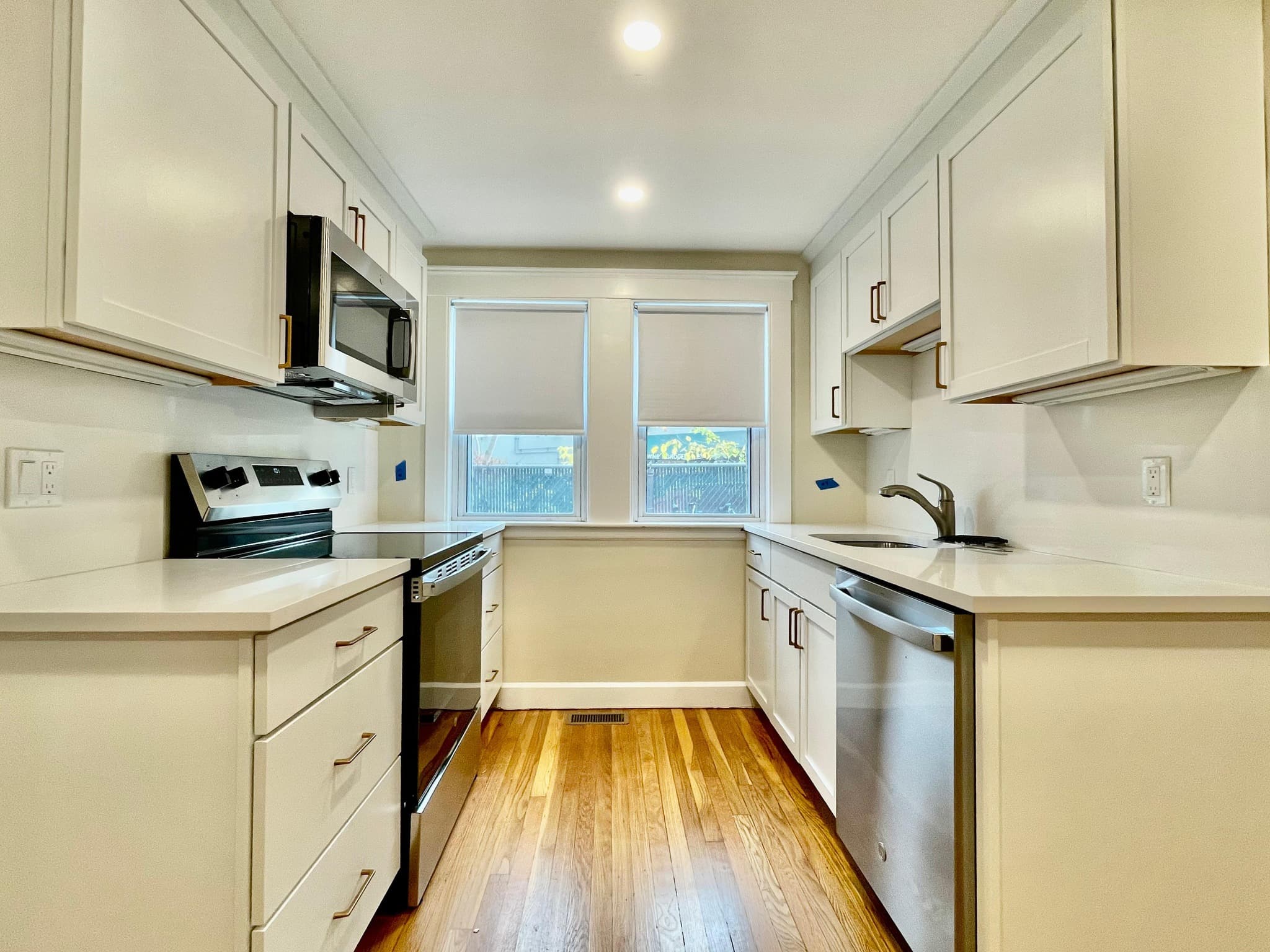 Bright galley kitchen with white cabinetry and modern finishes