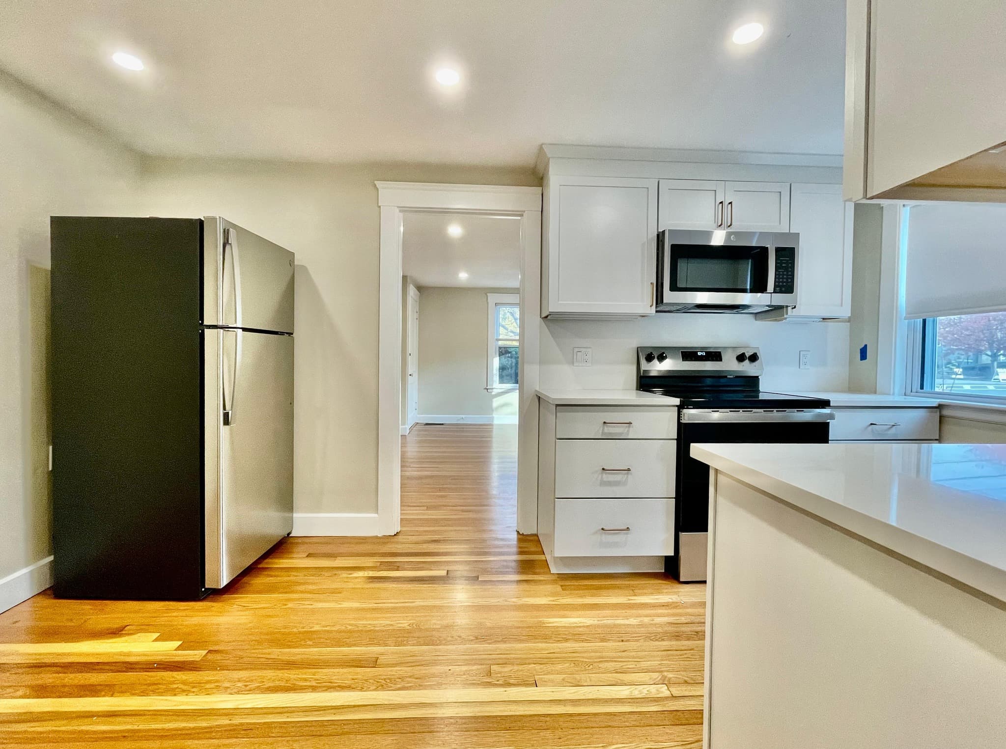 Modern kitchen with white cabinets and stainless steel appliances